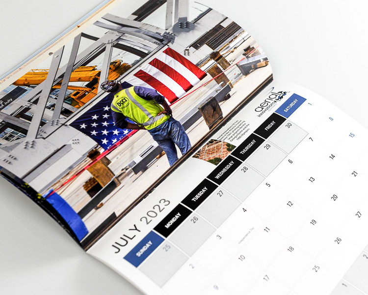 July calendar page featuring construction worker, steel framework, and infrastructure project photography