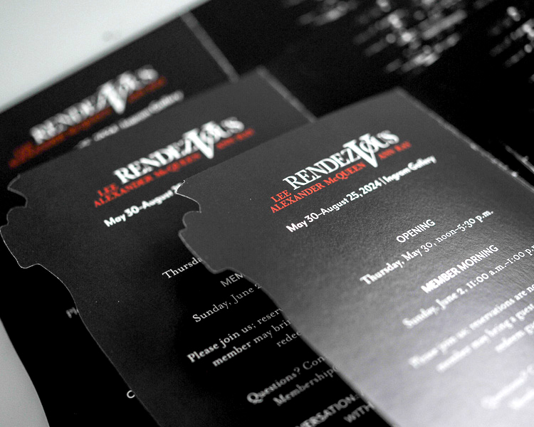 Stacked museum invitations with die-cut edges