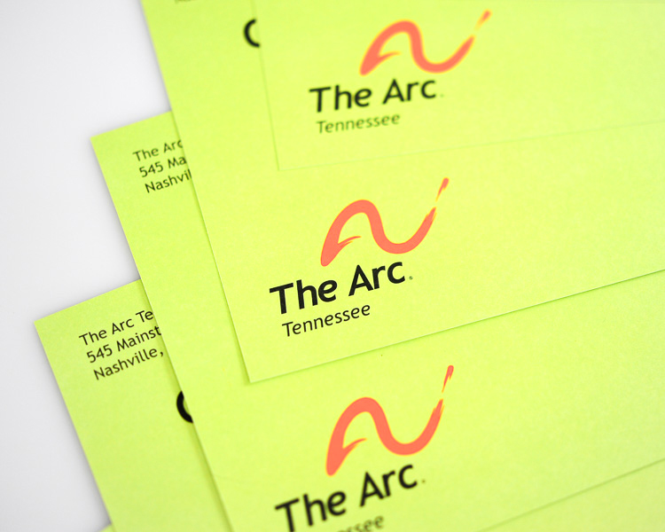 Close-up of The Arc postcard printing and typography